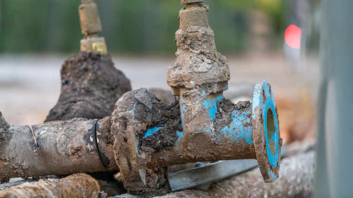 Corroded aging drinking water pipes and valves illustrating infrastructure challenges that drive lead monitoring and drinking water testing requirements. Corroded aging drinking water pipes and valves illustrating infrastructure challenges that drive lead monitoring and drinking water testing requirements.